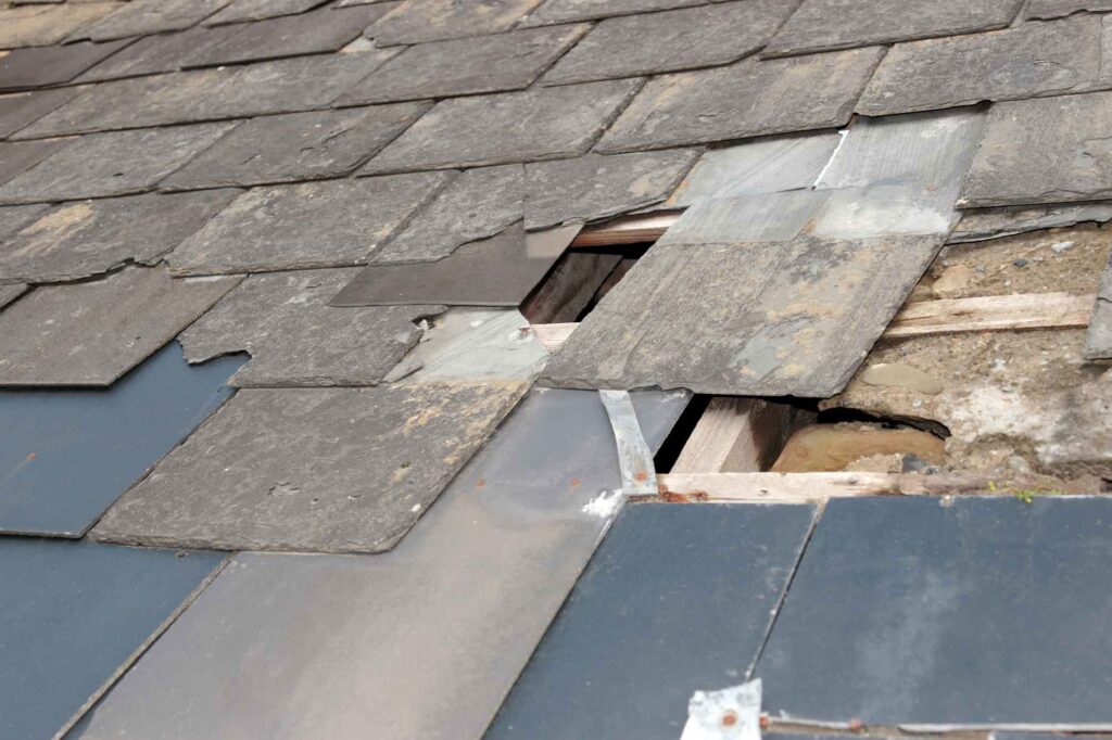 Damaged roof with broken slates