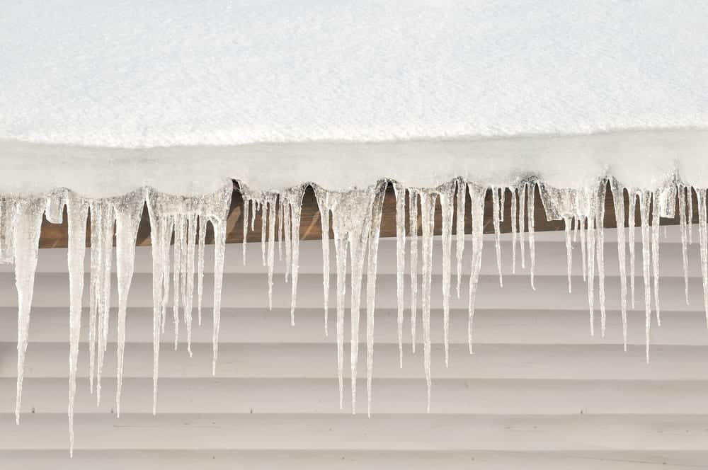 Snow and icicles on roof edge