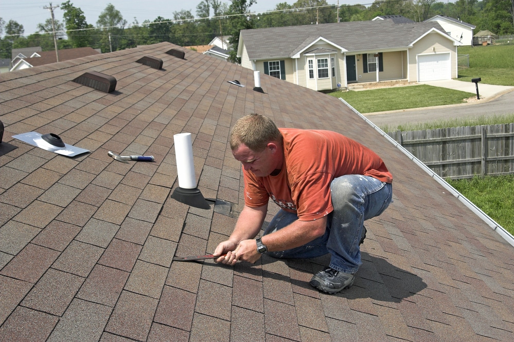 Roofer working on residential home roof