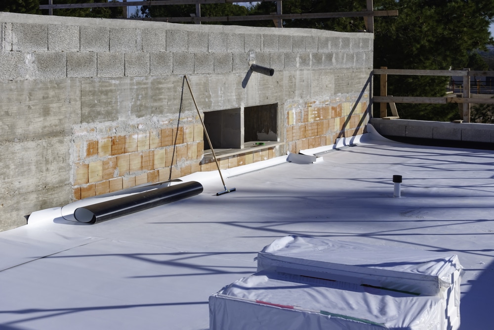 TPO roofing being applied to rooftop, in progress