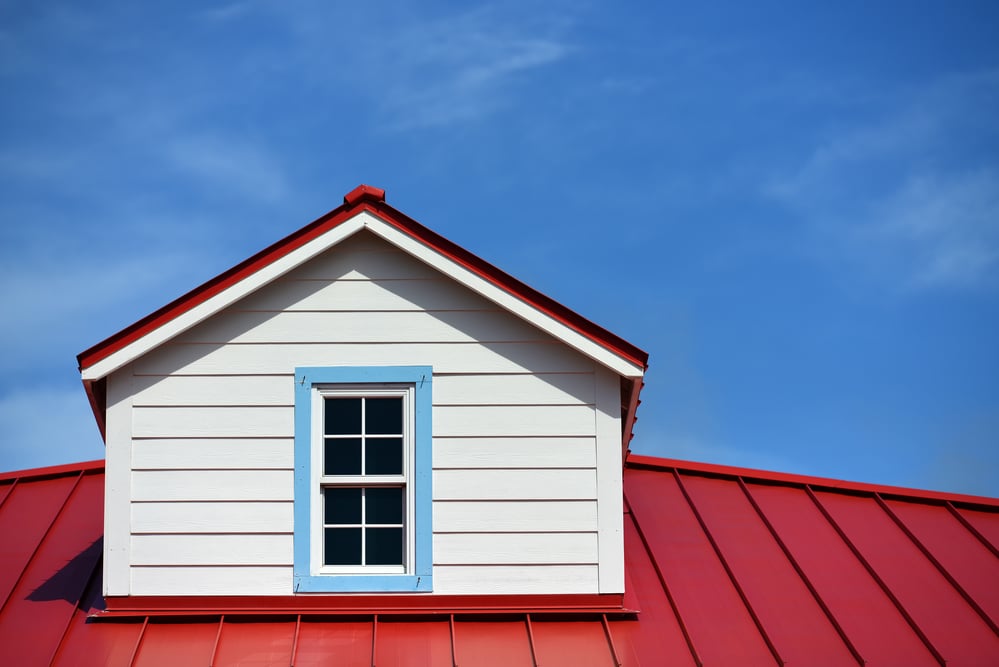 Red metal roof close-up, blue sky