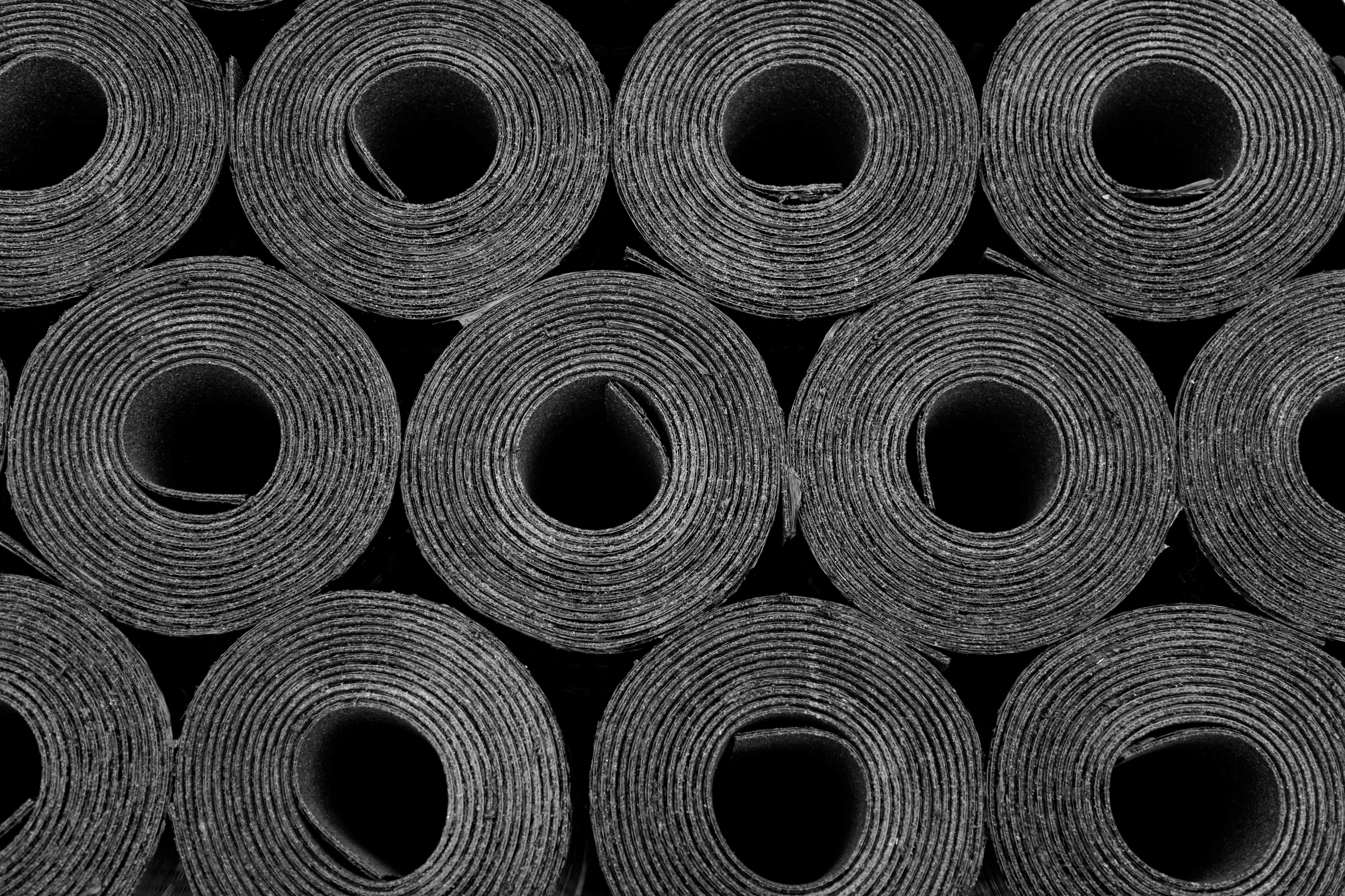 Rolls of black roofing felt or bitumen