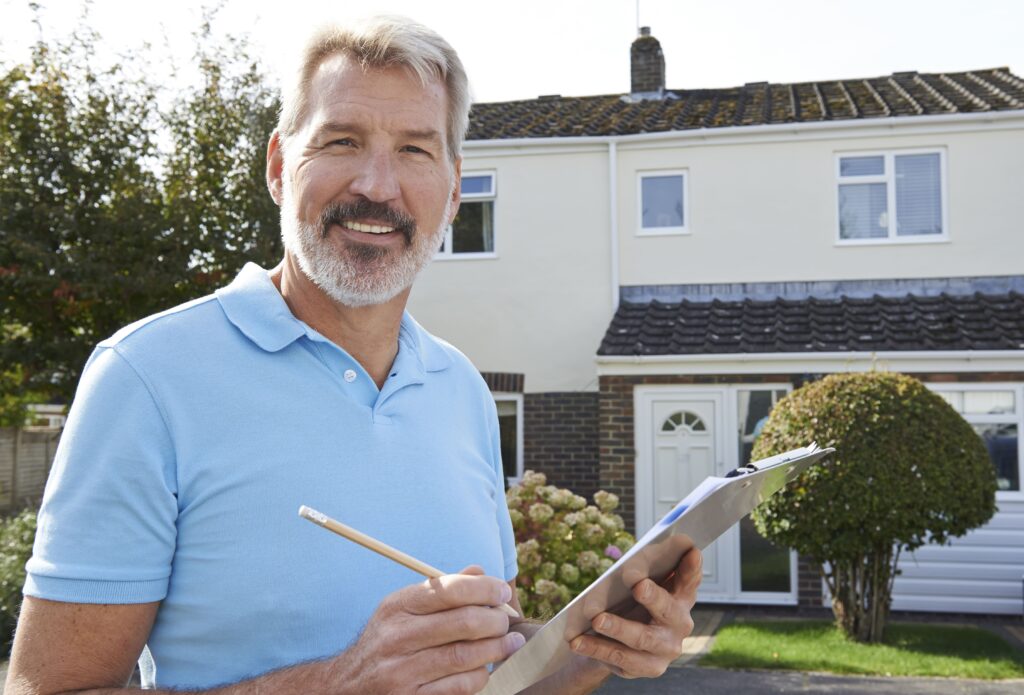 Roofer holding clipboard outside home