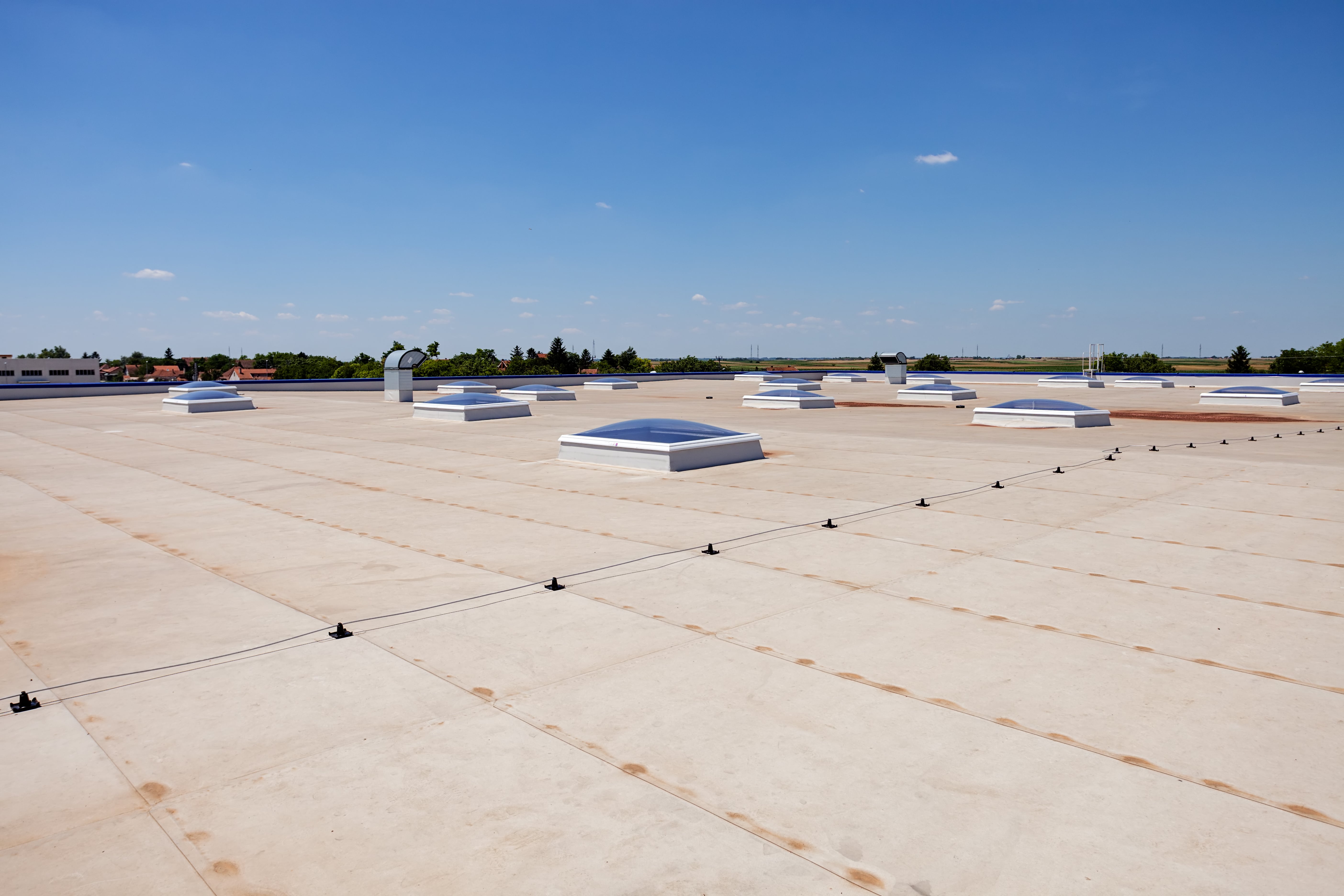 Flat commercial roof, blue sky