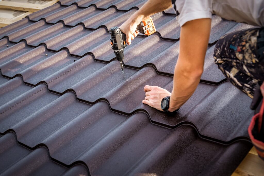 Roofer screws in metal roof tile
