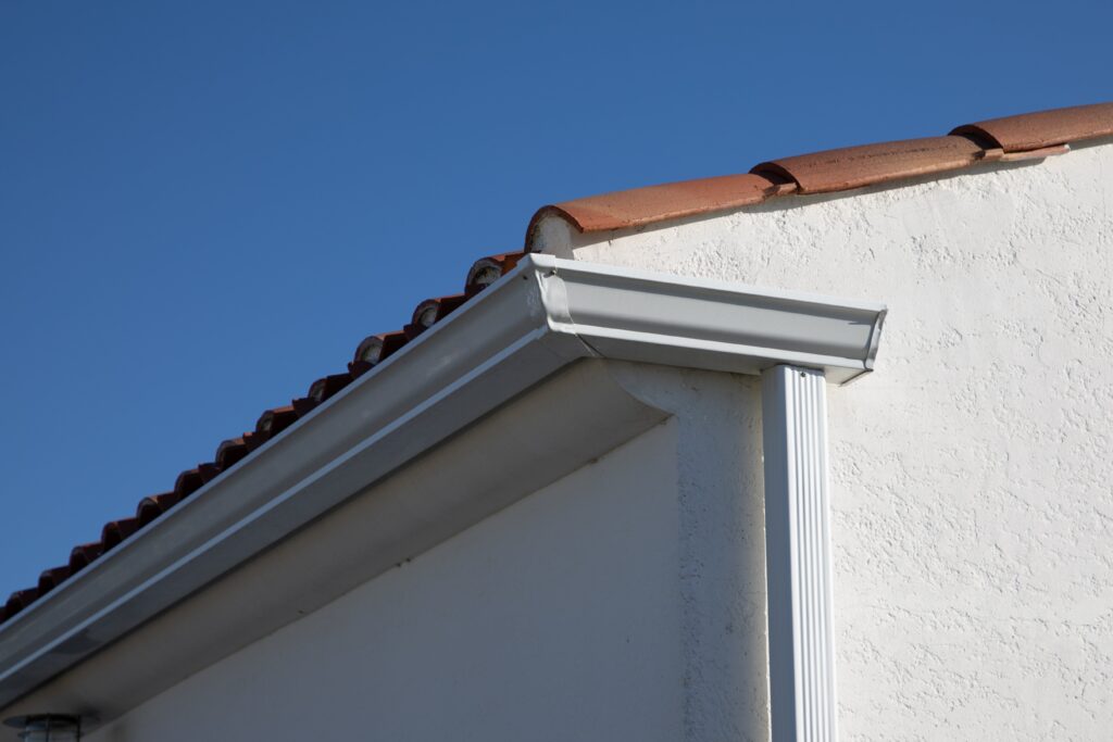 Seamless gutters attached to house with tile roof