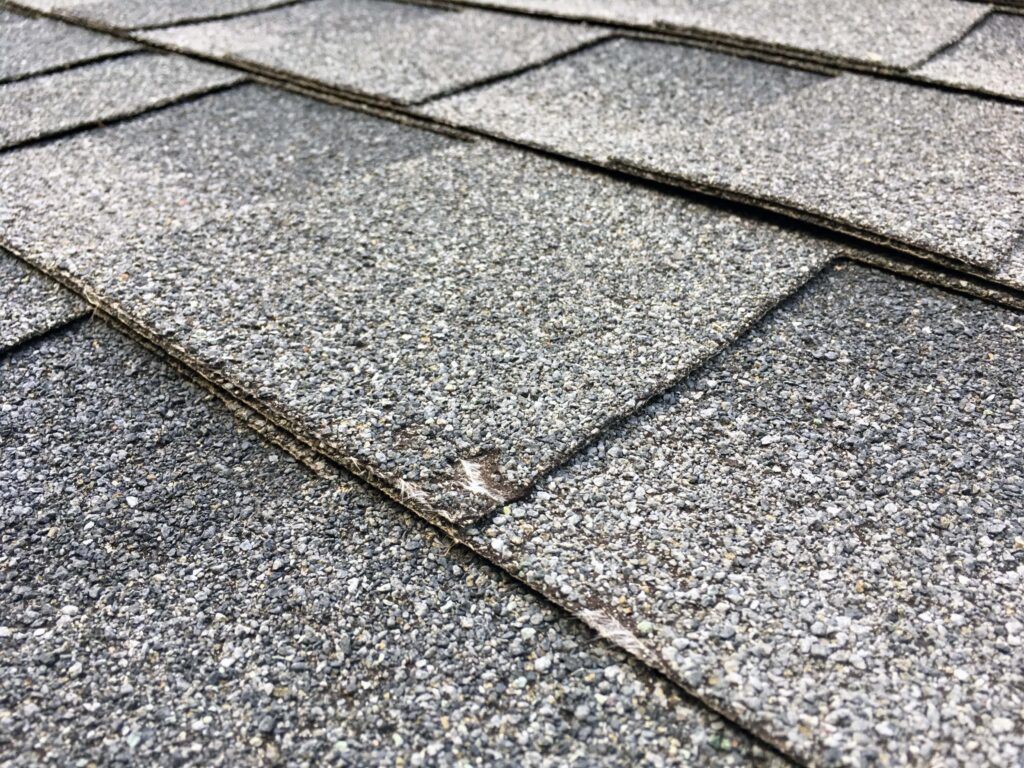 Close-up of hail damage on asphalt shingles