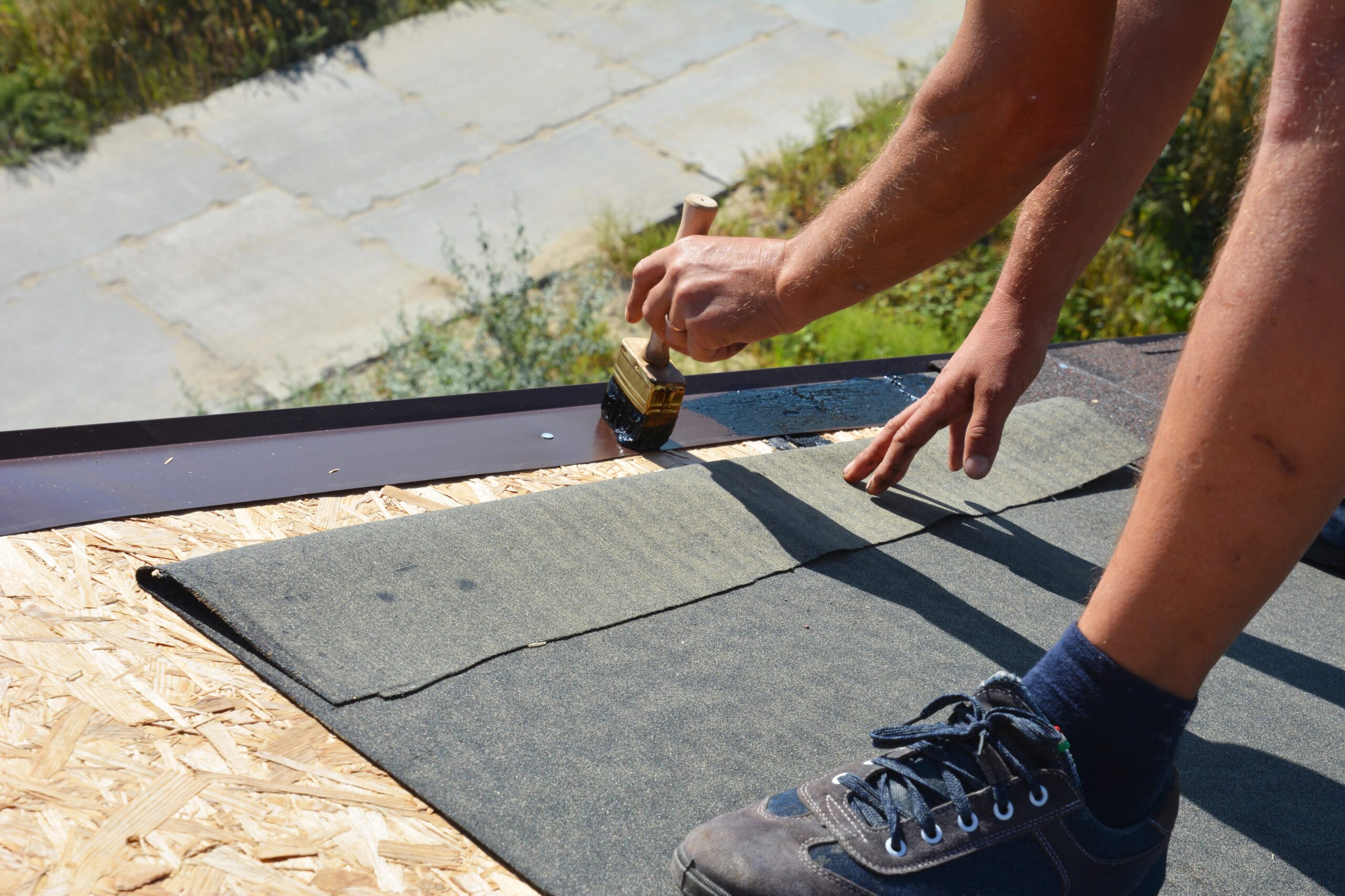 Roofer installing roof underlayment