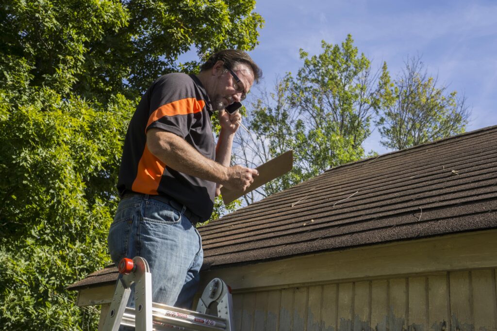 Man conducting roof inspection