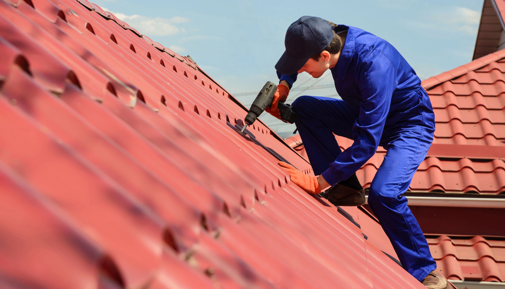 Close-up-of-young-happy-man-contractor-worker-in-blue-overal